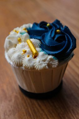 Lüks ve zarif kekler, beyaz kremalı ve lacivert üzerine altın serpiştirilmiş. Tatlı ve kremalı bir tadı var..