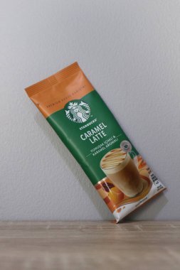 Bekasi, Indonesia on July 2022. Copy space starbucks caramel latte sachet, Starbucks premium instant coffee sachet original from Turkey. We can enjoy Starbucks coffee easily from home.