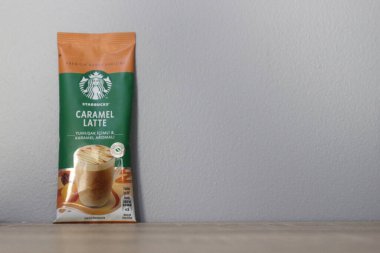 Bekasi, Indonesia on July 2022. Copy space starbucks caramel latte sachet, Starbucks premium instant coffee sachet original from Turkey. We can enjoy Starbucks coffee easily from home.