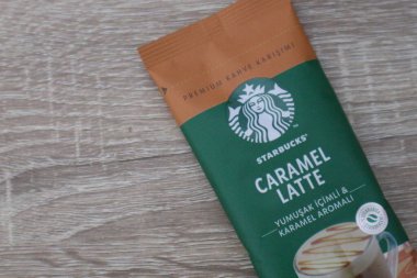 Bekasi, Indonesia on July 2022. Copy space starbucks caramel latte sachet, Starbucks premium instant coffee sachet original from Turkey. We can enjoy Starbucks coffee easily from home.