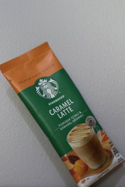 Bekasi, Indonesia on July 2022. Copy space starbucks caramel latte sachet, Starbucks premium instant coffee sachet original from Turkey. We can enjoy Starbucks coffee easily from home.