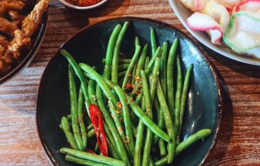 Saut the garlic chickpeas. The young chickpeas are not cut into pieces so that the texture remains crunchy. Saute with onions and chilies so it has a delicious and slightly spicy taste.