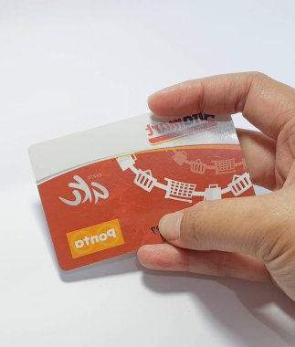 West Java, Indonesia on July 2022. Isolated photo of a hand holding a loyalty card, Alfa Gift Card. With this card, every time you make a transaction at Alfamart and Alfamidi stores. You will get points that can be exchanged for shopping vouchers.