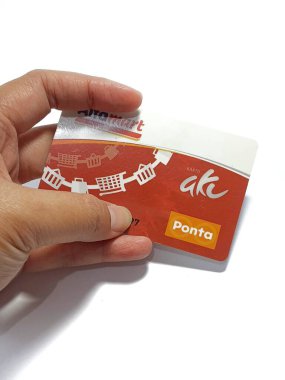 West Java, Indonesia on July 2022. Isolated photo of a hand holding a loyalty card, Alfa Gift Card. With this card, every time you make a transaction at Alfamart and Alfamidi stores. You will get points that can be exchanged for shopping vouchers.