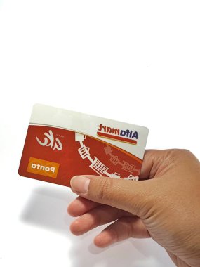 West Java, Indonesia on July 2022. Isolated photo of a hand holding a loyalty card, Alfa Gift Card. With this card, every time you make a transaction at Alfamart and Alfamidi stores. You will get points that can be exchanged for shopping vouchers.