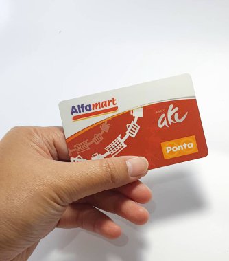 West Java, Indonesia on July 2022. Isolated photo of a hand holding a loyalty card, Alfa Gift Card. With this card, every time you make a transaction at Alfamart and Alfamidi stores. You will get points that can be exchanged for shopping vouchers.