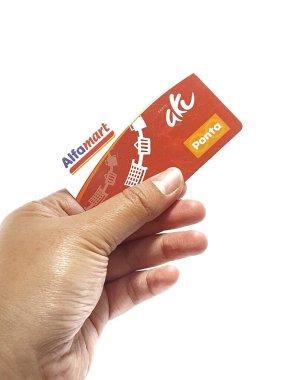 West Java, Indonesia on July 2022. Isolated photo of a hand holding a loyalty card, Alfa Gift Card. With this card, every time you make a transaction at Alfamart and Alfamidi stores. You will get points that can be exchanged for shopping vouchers.