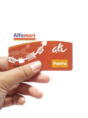 West Java, Indonesia on July 2022. Isolated photo of a hand holding a loyalty card, Alfa Gift Card. With this card, every time you make a transaction at Alfamart and Alfamidi stores. You will get points that can be exchanged for shopping vouchers.