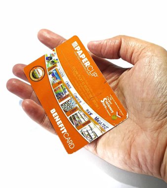 West Java, Indonesia on July 2022. Isolated photo of a hand holding a loyalty card, Benefit Card Paperclip. With this card, every time you make a transaction at a Paperclip shop, you will get points that can be exchanged for shopping vouchers.