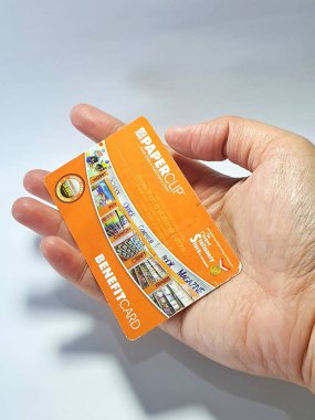 West Java, Indonesia on July 2022. Isolated photo of a hand holding a loyalty card, Benefit Card Paperclip. With this card, every time you make a transaction at a Paperclip shop, you will get points that can be exchanged for shopping vouchers.