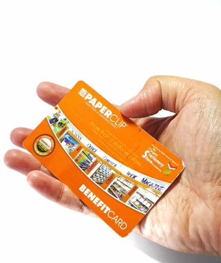 West Java, Indonesia on July 2022. Isolated photo of a hand holding a loyalty card, Benefit Card Paperclip. With this card, every time you make a transaction at a Paperclip shop, you will get points that can be exchanged for shopping vouchers.