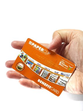 West Java, Indonesia on July 2022. Isolated photo of a hand holding a loyalty card, Benefit Card Paperclip. With this card, every time you make a transaction at a Paperclip shop, you will get points that can be exchanged for shopping vouchers.