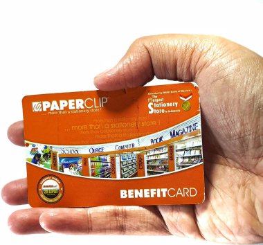 West Java, Indonesia on July 2022. Isolated photo of a hand holding a loyalty card, Benefit Card Paperclip. With this card, every time you make a transaction at a Paperclip shop, you will get points that can be exchanged for shopping vouchers.