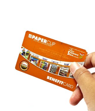 West Java, Indonesia on July 2022. Isolated photo of a hand holding a loyalty card, Benefit Card Paperclip. With this card, every time you make a transaction at a Paperclip shop, you will get points that can be exchanged for shopping vouchers.
