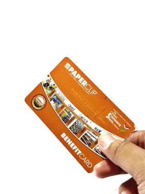 West Java, Indonesia on July 2022. Isolated photo of a hand holding a loyalty card, Benefit Card Paperclip. With this card, every time you make a transaction at a Paperclip shop, you will get points that can be exchanged for shopping vouchers.