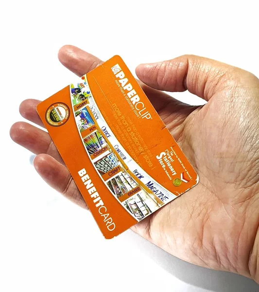 West Java, Indonesia on July 2022. Isolated photo of a hand holding a loyalty card, Benefit Card Paperclip. With this card, every time you make a transaction at a Paperclip shop, you will get points that can be exchanged for shopping vouchers.