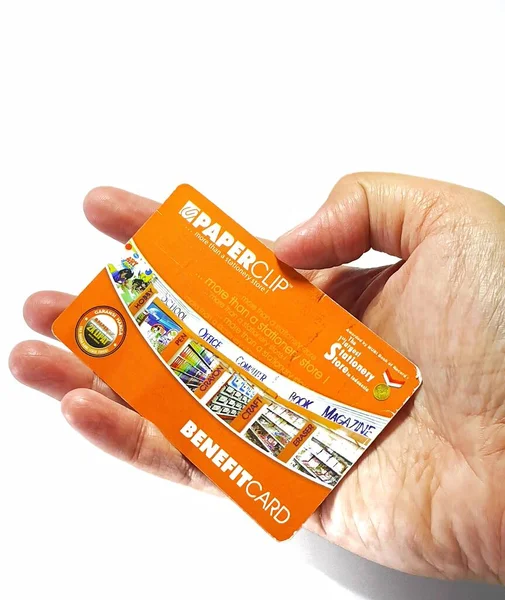West Java, Indonesia on July 2022. Isolated photo of a hand holding a loyalty card, Benefit Card Paperclip. With this card, every time you make a transaction at a Paperclip shop, you will get points that can be exchanged for shopping vouchers.