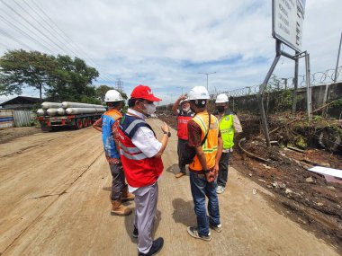 Jakarta, Indonesia in July 2022. Several men holding a project work progress meeting. Looks seriously discussing the continuity of the project.