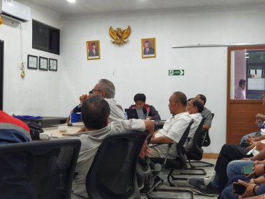 Jakarta, Indonesia in July 2022. Several men holding a project work progress meeting. Looks seriously discussing the continuity of the project.