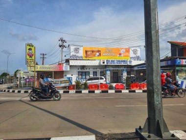 Central Java, Indonesia in November 2022. Police Station Turjawali Unit of the Tegal Police Traffic Unit. Emergency PPKM Pospam 2021 Tegal Police. Above it is a banner advertising Wasgitel Tea Poci.