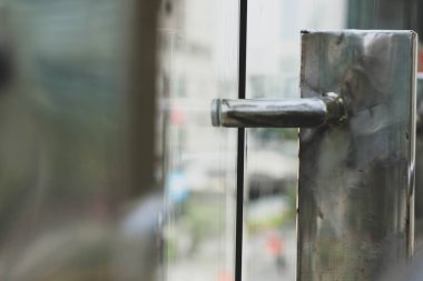 Steel trellis from a separator fence at a transjakarta busway stop. Made of aluminium steel with shiny color and glass.