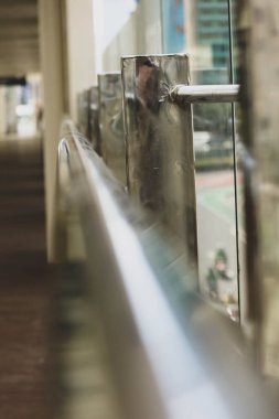 Steel trellis from a separator fence at a transjakarta busway stop. Made of aluminium steel with shiny color and glass.
