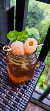 This is a fresh lychee tea. Where two lychees are stabbed and placed on a glass for garnish and added beautifully with mint leaves. Very refreshing and a relief from thirst.