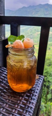 This is a fresh lychee tea. Where two lychees are stabbed and placed on a glass for garnish and added beautifully with mint leaves. Very refreshing and a relief from thirst.