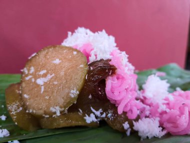 Traditional Jepara food, namely Gethuk putu mayang mixed gendar which is given grated coconut. Wrapped in banana leaves.