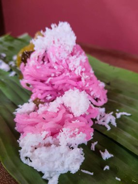 Traditional Jepara food, namely Gethuk putu mayang mixed gendar which is given grated coconut. Wrapped in banana leaves.