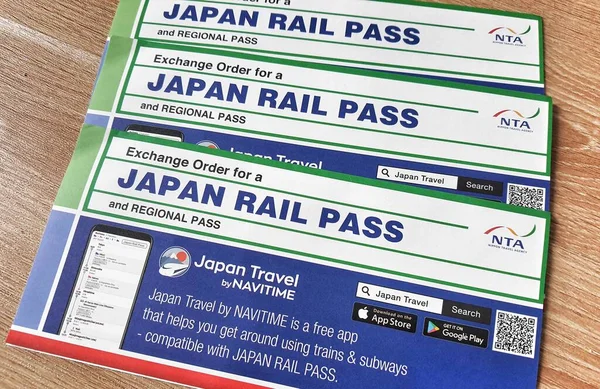 stock image Jakarta, Indonesia on July 31, 2023. Three sheets of Exchange Order for a Japan Rail Pass and regional pass paper in order to get your JR Pass once you arrive in Japan.