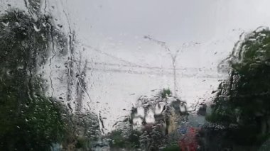 Bekasi, Endonezya 8 Aralık 2023. Yağmurlu koşullarda arabada olan bir araba sürücüsünün bakış açısı, araç durduruldu, motor hala çalışıyor, silecekler çalışıyor. Hüzünlü atmosfer.