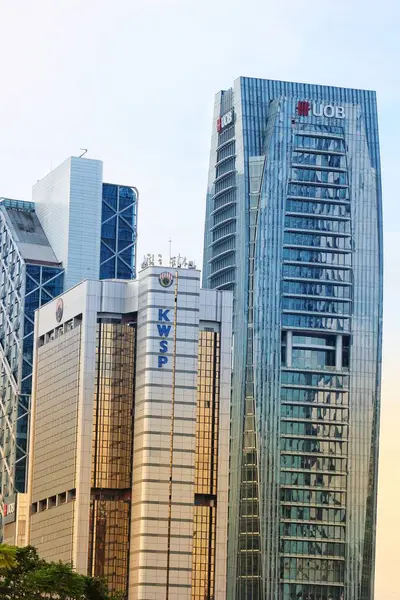 stock image Kuala Lumpur, Malaysia on May 22, 2023. Close up photo of the United Overseas Bank UOB Bank Office Tower, next to which is the KWSP Malaysia Kumpulan Wang Simpanan Kerja office building.