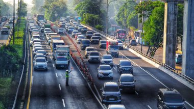 Jakarta, July 4 2024. Very congested traffic in the morning on Jalan MT Haryono, Cawang. Traffic jams cannot be avoided because many office employees use cars to go to work. Office area. clipart