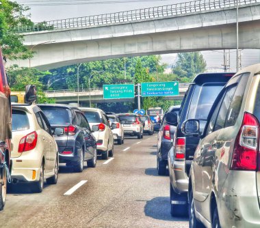 Jakarta, September 5 2024. Very congested traffic in the morning on Jalan MT Haryono, Cawang. Traffic jams cannot be avoided because many office employees use cars to go to work. Office area. clipart