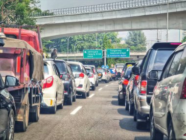 Jakarta, September 5 2024. Very congested traffic in the morning on Jalan MT Haryono, Cawang. Traffic jams cannot be avoided because many office employees use cars to go to work. Office area. clipart