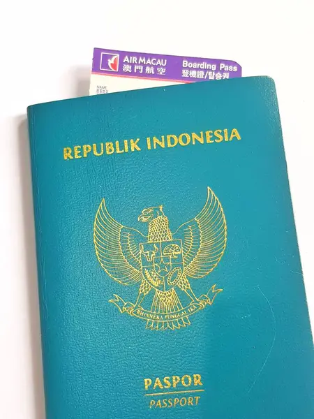 Macau, Çin 14 Kasım 2024. Endonezya pasaportunun içinde Macau Havayolları 'nın giriş kartı var. Ulusal amblem belirgin, resmi seyahat hazırlığı hissi yaratıyor..