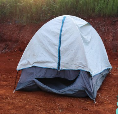 Kamp tarafındaki açık alanda tam donanımlı bir kamp çadırı.