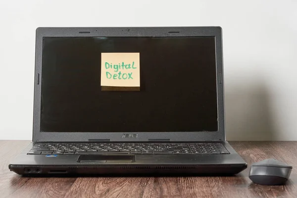 a laptop with a sticky sticker attached to the screen that saysdelxon it, sitting on a wooden desk