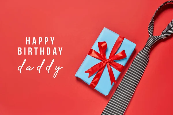 赤いリボンがついた青いギフトボックスと上に白い文字で書かれた幸せの誕生日 — ストック写真