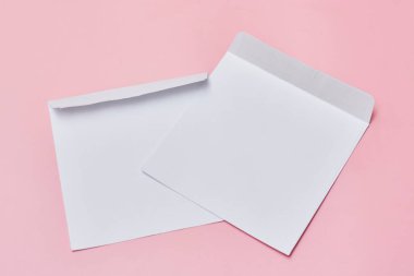 two white envelopes on a pink background with copy space for your text or message, top view stock photo