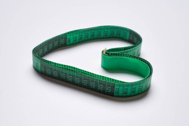 a measuring tape in the shape of a heart on a white background, with copy space for your text stock photo