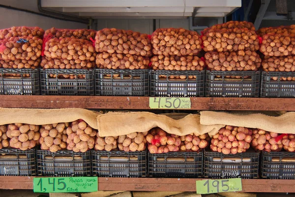 Stock image Street stall selling potatoes to make wrinkles in Tenerife and on the top shelf many mayas of country nuts in plastic boxes just like potatoes, with the prices of the products written on colored paper