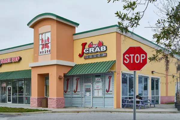 stock image Florida, USA - March 23, 2024: The image captures the diversity of a shopping plaza with a barber shop and a seafood restaurant, creating a vibrant and welcoming environment.