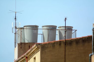 A detailed view of water tanks on a building, showing a unique urban scene. clipart