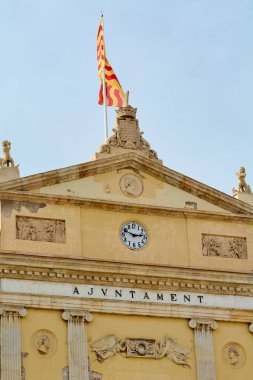 Tarragona, Spain - April 17, 2024: A stunning view of Tarragona Town Hall, highlighting its classic architecture, ornamental details and a clock on top. clipart