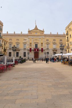 Tarragona, Spain - April 17, 2024: Detailed image of Tarragona town hall, showing classical architecture, sculptures and a clock on top. clipart