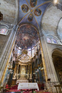 Lugo, Spain - May 10, 2024: Lugo Cathedral reveals itself in its splendor, with a focus on the richly adorned altar, bathed in soft light that enhances every detail. clipart