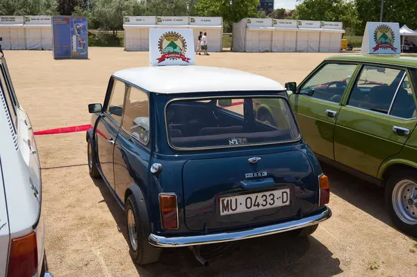 stock image Viladecasn, SPAIN - JULY 26, 2024: Picture of a classic blue Mini Cooper with white roof, parked on sandy ground. Perfect for classic car enthusiasts and collectors.