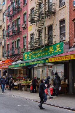 New York, United States -September 07,2024: Street view of New York s vibrant Chinatown featuring a local vegetable shop with fresh produce and iconic architecture. clipart